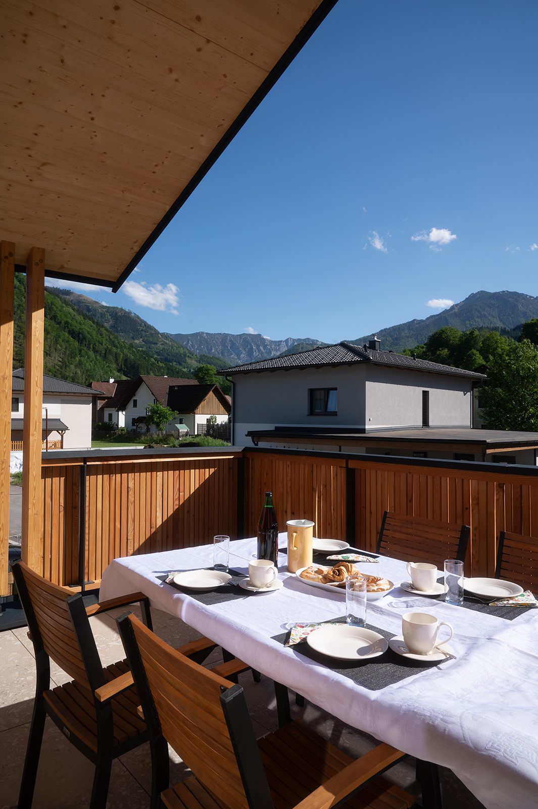 A laid table on a terrace with mountain views.